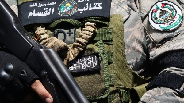 A fighter of the Ezzedine al-Qassam Brigades, attends the funeral of Samer al-Hajj, a commander of the Palestinian militant group Hamas who was killed a day earlier in an Israeli strike on a vehicle in the southern Lebanese city of Sidon, at the nearby Ain al-Helweh Palestinian refugee camp on August 10, 2024. (Photo by Mahmoud ZAYYAT / AFP)