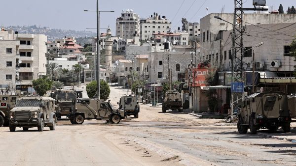 Israeli army vehicles block the entrance to the Tulkarem camp for Palestinian refugees, in the occupied Palestinian West Bank on August 22, 2024. (Photo by Zain JAAFAR / AFP) West Bank
