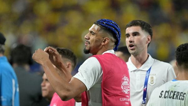 Uruguay's defender #04 Ronald Araujo reacts as Uruguay's supporters, including players' relatives, clash with Colombia's supporter, at the end of the Conmebol 2024 Copa America tournament semi-final football match between Uruguay and Colombia at Bank of America Stadium, in Charlotte, North Caroline on July 10, 2024. (Photo by JUAN MABROMATA / AFP)