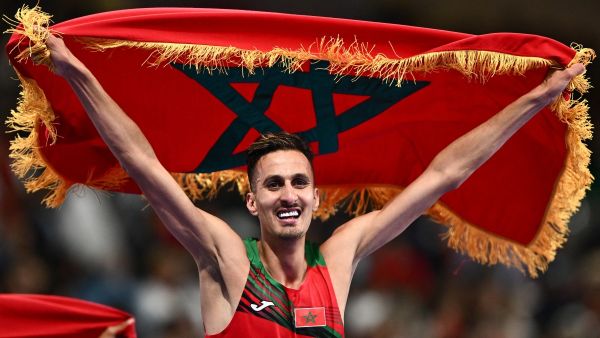 Morocco's Soufiane El Bakkali celebrates after winning the men's 3000m steeplechase final of the athletics event at the Paris 2024 Olympic Games at Stade de France in Saint-Denis, north of Paris, on August 7, 2024. (Photo by Jewel SAMAD / AFP)