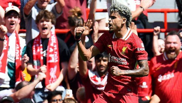 Liverpool's Colombian midfielder #07 Luis Diaz celebrates scoring the team's second goal during the pre-season friendly football match between Liverpool and Sevilla at Anfield stadium in Liverpool, northwest England on August 11, 2024. (Photo by Peter POWELL / AFP)