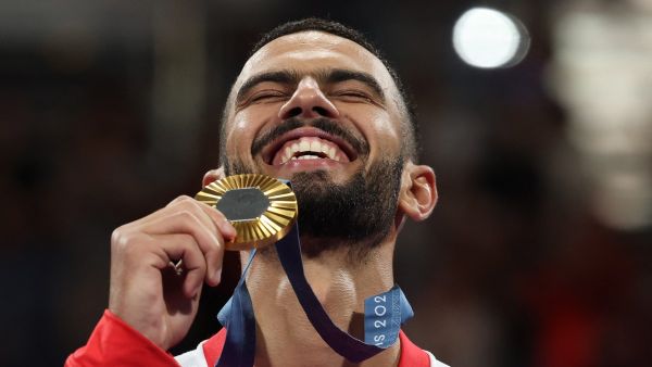 Gold medallist Tunisia's Firas Katoussi celebrates on the podium during the medal ceremony for the taekwondo men's -80kg competition of the Paris 2024 Olympic Games at the Grand Palais in Paris on August 9, 2024. (Photo by David GRAY / AFP)