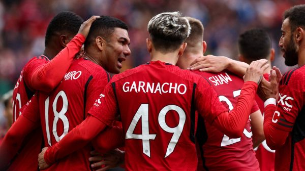 Manchester United's Brazilian midfielder Casemiro (L) celebrates scoring his team third goal during the pre-season friendly football match between Manchester United and Lens at Old Trafford stadium, in Manchester, on August 5, 2023. (Photo by Darren Staples / AFP)