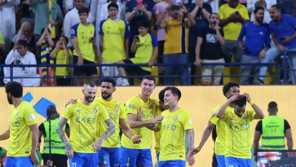 Nassr's Portuguese forward #07 Cristiano Ronaldo celebrates with teammates after scoring his second goal during the Saudi Pro League football match between Al-Ittihad and Al-Nassr at the King Saud University Stadium in Riyadh on May 27, 2024. (Photo by Fayez NURELDINE / AFP)