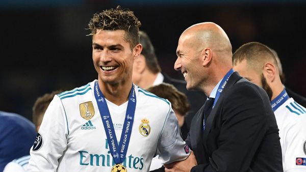 Real Madrid's former French coach Zinedine Zidane (R) celebrates with Real Madrid's former Portuguese forward Cristiano Ronaldo after winning the UEFA Champions League final football match between Liverpool and Real Madrid at the Olympic Stadium in Kiev, Ukraine, on May 26, 2018. (Photo by FRANCK FIFE / AFP)