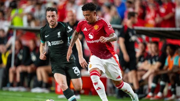 Jadon Sancho #25 of Manchester United takes the ball past Diogo Jota #20 of Liverpool in the first half during their pre-season friendly match at Williams-Brice Stadium on August 03, 2024 in Columbia, South Carolina. Jacob Kupferman/Getty Images/AFP (Photo by Jacob Kupferman / GETTY IMAGES NORTH AMERICA / Getty Images via AFP)