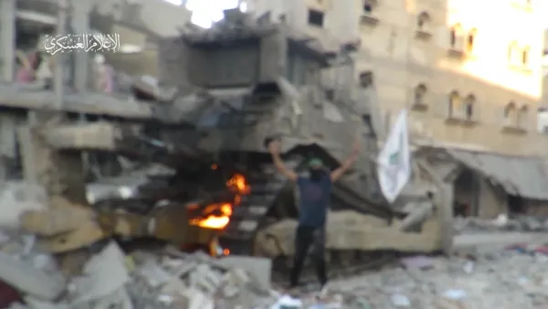 Video: Hamas fighter raises flag on Israeli tank then burns it