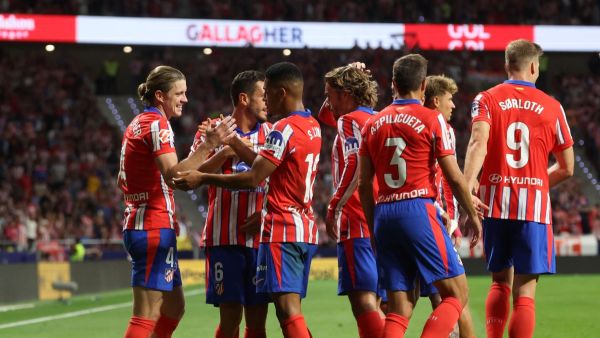 Atletico Madrid's English midfielder #04 Conor Gallagher celebrates with teammates scoring his team's first goal during the Spanish league football match between Club Atletico de Madrid and Valencia CF at the Metropolitano stadium in Madrid on September 15, 2024. (Photo by Pierre-Philippe MARCOU / AFP)
