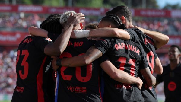 Barcelona's Spanish forward #20 Daniel Olmo celebrates with teammates scoring his team's third goal during the Spanish league football match between Girona FC and FC Barcelona at the Montilivi stadium in Girona on September 15, 2024. (Photo by LLUIS GENE / AFP)