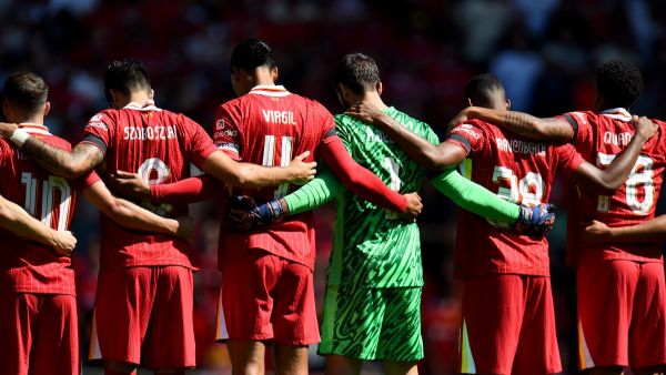 Players observe a minute's silence for the victims of the Southport attack before the pre-season friendly football match between Liverpool and Sevilla at Anfield stadium in Liverpool, northwest England on August 11, 2024. (Photo by Peter POWELL / AFP)
