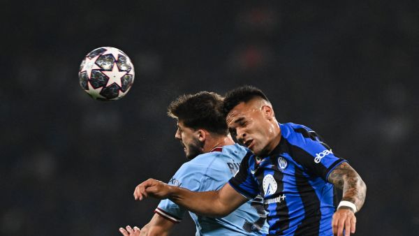Manchester City's Portuguese defender #3 Ruben Dias (L) vies to header the abll against Inter Milan's Argentinian forward #10 Lautaro Martinez during the UEFA Champions League final football match between Inter Milan and Manchester City at the Ataturk Olympic Stadium in Istanbul, on June 10, 2023. (Photo by Paul ELLIS / AFP)