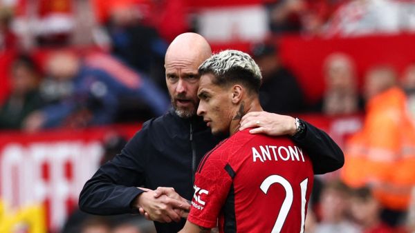 Manchester United's Brazilian midfielder Antony (R) is congratulated by Manchester United's Dutch manager Erik ten Hag (L) as he leaves the pitch during the pre-season friendly football match between Manchester United and Lens at Old Trafford stadium, in Manchester, on August 5, 2023. (Photo by Darren Staples / AFP)