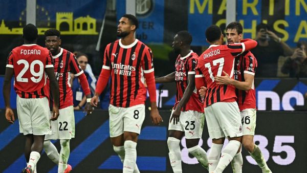 AC Milan's Italian defender #46 Matteo Gabbia (R) celebrates with teammates after scoring his team's second goal during the Italian Serie A football match between Inter and AC Milan at San Siro stadium in Milan, on September 22, 2024. (Photo by Gabriel BOUYS / AFP)
