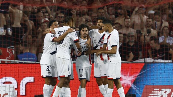 Paris Saint-Germain's Portuguese midfielder #17 Vitinha (C) is congratulated by teammates after scoring PSG's first goal during the French L1 football match between Lille LOSC and Paris Saint-Germain (PSG) at the Stade Pierre-Mauroy in Villeneuve-d'Ascq, northern France, on September 1, 2024. (Photo by DENIS CHARLET / AFP)