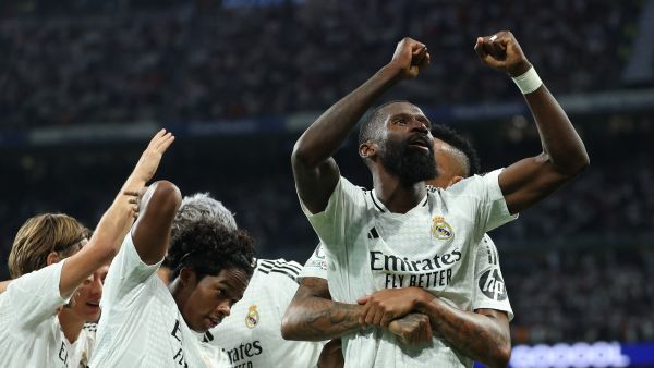 Real Madrid's German defender #22 Antonio Ruediger celebrates with teammates after scoring his team's second goal during the UEFA Champions League 1st round day 1 football match between Real Madrid CF and Stuttgart VFB at the Santiago Bernabeu stadium in Madrid on September 17, 2024. (Photo by Thomas COEX / AFP)