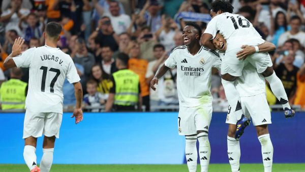 Real Madrid's French forward #09 Kylian Mbappe (R BOTTOM) celebrates with Real Madrid's Brazilian forward #16 Endrick (TOP) and Real Madrid's Brazilian forward #07 Vinicius Junior after scoring his team's fourth goal from the penalty spot during the Spanish league football match between Real Madrid CF and RCD Espanyol at the Santiago Bernabeu stadium in Madrid, on September 21, 2024. (Photo by Thomas COEX / AFP)