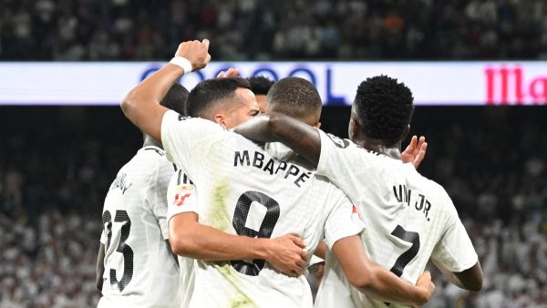 Real Madrid's French forward #09 Kylian Mbappe celebrates with teammates scoring his team's second goal during the Spanish league football match between Real Madrid CF and Deportivo Alaves at the Santiago Bernabeu stadium in Madrid on September 24, 2024. (Photo by JAVIER SORIANO / AFP)