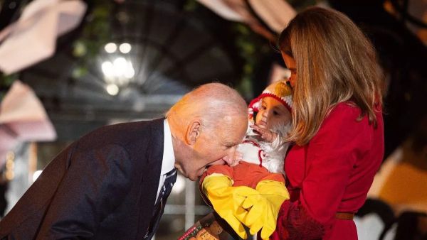 US President Joe Biden jokingly bites a baby dressed as a chicken as he hosts a Halloween trick-or-treat event at the South Portico of the White House in Washington, DC (Image: AFP via Getty Images) US President Joe Biden marks Halloween 2024