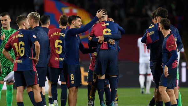 Barcelona's Spanish midfielder #06 Pablo Gavi hugs teammates at the end of the Spanish league football match between FC Barcelona and Sevilla FC at the Estadi Olimpic Lluis Companys in Barcelona on October 20, 2024. (Photo by Josep LAGO / AFP)