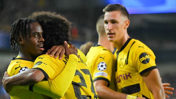 Borussia Dortmund's English forward #43 Jamie Bynoe-Gittens (L) celebrates with teammates after scoring his team's second goal during the UEFA Champions League's 1st round day 1 football match between Club Brugge KV and Borussia Dortmund at the Jan Breydel Stadium in Bruges on September 18, 2024. (Photo by NICOLAS TUCAT / AFP)