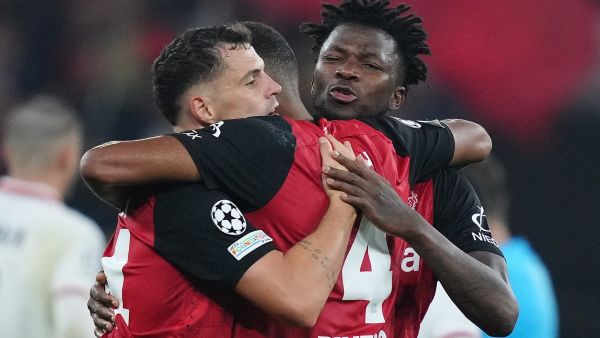 Bayer Leverkusen's Swiss midfielder #34 Granit Xhaka, Bayer Leverkusen's Burkinabe defender #12 Edmond Tapsoba and Bayer Leverkusen's German defender #04 Jonathan Tah celebrate after the UEFA Champions League football match between Bayer 04 Leverkusen and AC Milan in Leverkusen, western Germany on October 1, 2024. (Photo by Pau BARRENA / AFP)