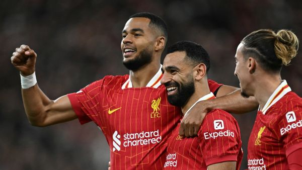 Liverpool's Egyptian striker #11 Mohamed Salah celebrates scoring the team's second goal during the UEFA Champions League league stage football match between Liverpool and Bologna at Anfield in Liverpool, north west England on October 2, 2024. (Photo by Paul ELLIS / AFP)