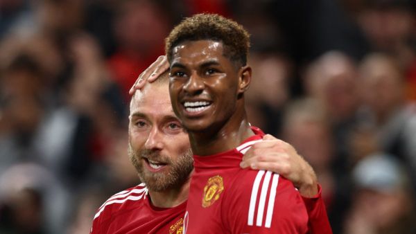 Manchester United's Danish midfielder #14 Christian Eriksen (L) celebrates with Manchester United's English striker #10 Marcus Rashford after scoring his teams first goal during the UEFA Europa league stage football match between Manchester United and FC Twente at Old Trafford stadium in Manchester, north west England, on September 25, 2024. (Photo by Darren Staples / AFP)