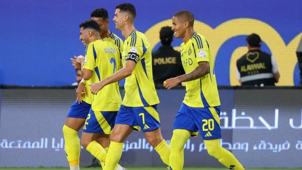 Nassr's Portuguese forward #07 Cristiano Ronaldo celebrates with his team after scoring their second goal during the Saudi Pro League football match between Al-Nassr and Al-Wehda at Al -Awwal Stadium in Riyadh on September 27, 2024. (Photo by Fayez NURELDINE / AFP)