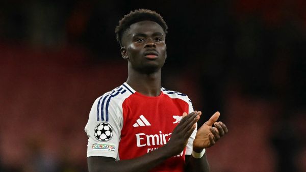 Arsenal's English midfielder #07 Bukayo Saka applauds the fans following during the UEFA Champions League football match between Arsenal and Paris Saint-Germain (PSG) at the Emirates Stadium in north London on October 1, 2024. Arsenal won the match 2-0. (Photo by Glyn KIRK / AFP)