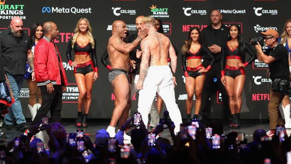 IRVING, TEXAS - NOVEMBER 14: Mike Tyson slaps Jake Paul as they face off during their ceremonial weigh-in 