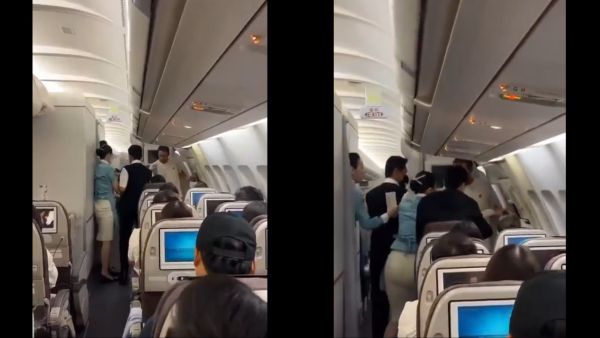 Passenger attempts to jump from plane mid-flight due to seat dispute