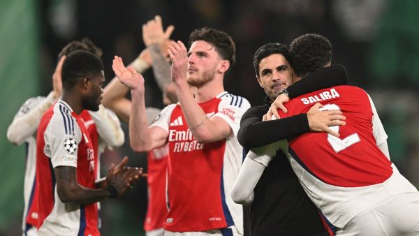 Arsenal's Spanish coach Mikel Arteta (2R) hugs Arsenal's French defender #02 William Saliba at the end of the UEFA Champions League, league phase day 5 football match between Sporting CP and Arsenal FC, at the Jose Alvalade stadium in Lisbon, on November 26, 2024. (Photo by PATRICIA DE MELO MOREIRA / AFP)