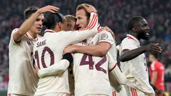 Bayern Munich's German midfielder #42 Jamal Musiala (C) celebrates with teammates after scoring the 1-0 opening goal during the UEFA Champions League football match FC Bayern Munich vs SL Benfica in Munich, southern Germany, on November 6, 2024. (Photo by Tobias SCHWARZ / AFP)