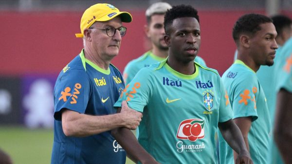 Brazil’s coach Dorival Junior (L) gives instructions to Vinicius Junior as they take part in a training session of the Brazil national football team at the Manuel Barradas stadium in Salvador, Bahia State, Brazil, on November 17, 2024, ahead of the 2026 FIFA World Cup qualifier football match against Uruguay. (Photo by Nelson ALMEIDA / AFP)