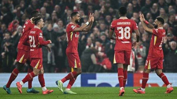 Liverpool's Dutch striker #18 Cody Gakpo (C) celebrates after scoring his team second goal during the UEFA Champions League football match between Liverpool and Bayer Leverkusen at Anfield stadium, in Liverpool, north west England, on November 5, 2024. (Photo by Paul ELLIS / AFP)