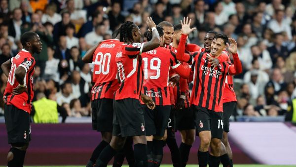 AC Milan's Dutch midfielder #14 Tijani Reijnders (R) celebrates scoring their third goal during the UEFA Champions League, league phase day 4 football match between Real Madrid CF and AC Milan at the Santiago Bernabeu stadium in Madrid on November 5, 2024. (Photo by OSCAR DEL POZO / AFP)