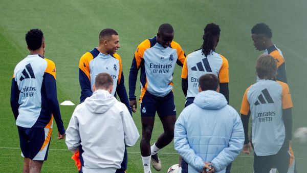 Real Madrid's French forward #09 Kylian Mbappe (2L) talks with teammates during a training session at the club's training facilities of Valdebebas, in the outskirts of Madrid, on November 8, 2024, on the eve of their Spanish league football match against CA Osasuna. (Photo by OSCAR DEL POZO / AFP)