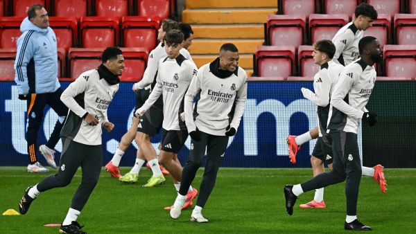 Real Madrid's English midfielder #5 Jude Bellingham (L) and Real Madrid's French forward #09 Kylian Mbappe (C) take part in a training session, at Anfield Stadium in Liverpool, north west England, on November 26, 2024, on the eve of their UEFA Champions League football match against Liverpool. (Photo by Paul ELLIS / AFP)