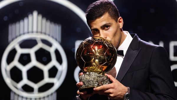 Manchester City's Spanish midfielder Rodri kisses the trophy as he receives the Ballon d'Or award during the 2024 Ballon d'Or France Football award ceremony at the Theatre du Chatelet in Paris on October 28, 2024. (Photo by FRANCK FIFE / AFP)