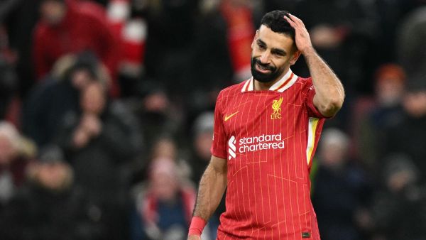 Liverpool's Egyptian striker #11 Mohamed Salah reacts after failing to score from the penalty spot during the UEFA Champions League football match between Liverpool and Real Madrid at Anfield in Liverpool, north west England on November 27, 2024. (Photo by Oli SCARFF / AFP)