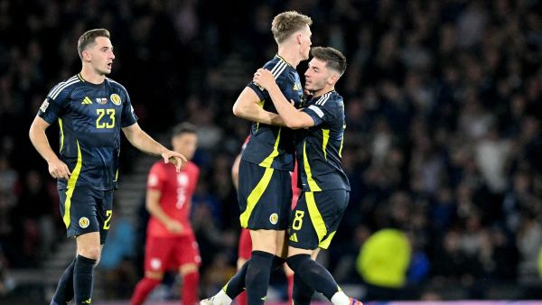 Scotland's midfielder #08 Billy Gilmour (R) celebrates with Scotland's midfielder #04 Scott McTominay (C) and Scotland's midfielder #23 Kenny McLean scoring the team's first goal during the UEFA Nations League League A Group 1 football match between Scotland and Poland, at Hampden Park stadium, in Glasgow, on September 5, 2024. (Photo by ANDY BUCHANAN / AFP)
