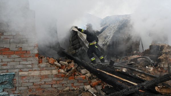 A rescuer of the State Emergency Service works to put out a fire in a private house after a drone strike in Kharkiv, on December 25, 2024, amid the Russian invasion in Ukraine. (Photo by SERGEY BOBOK / AFP) Video: Attempted car bomb assassination on Russian official prevented