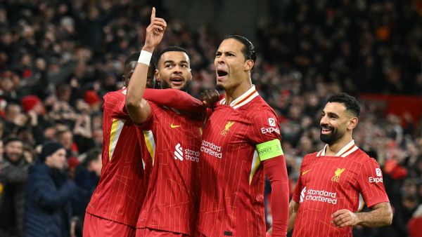 Liverpool's Dutch striker #18 Cody Gakpo (2L) celebrates scoring the team's second goal with Liverpool's Dutch defender #04 Virgil van Dijk during the UEFA Champions League football match between Liverpool and Real Madrid at Anfield in Liverpool, north west England on November 27, 2024. (Photo by Oli SCARFF / AFP)