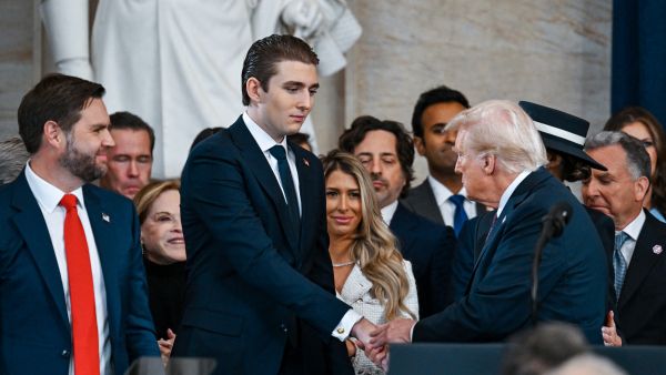 U.S. President Donald Trump shakes hands with his son Barron Trump as Vice President JD Vance looks on during his inauguration in the U.S. Capitol Rotunda on January 20, 2025 in Washington, DC. (Photo by POOL / GETTY IMAGES NORTH AMERICA / Getty Images via AFP)  Barron Trump