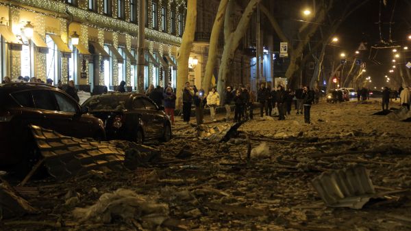 Onlookers gather around a damaged hotel