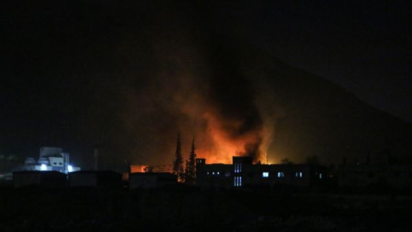 Syrians check the damage after Israeli troops