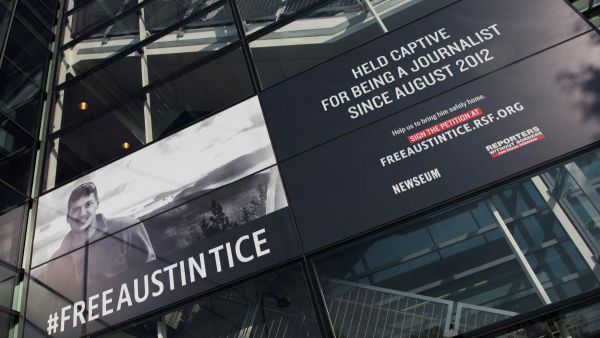 A banner calling for the release of Austin Tice, the only American journalist held captive in Syria, is displayed at the Newseum in Washington, DC on November 2, 2016. (Photo by ANDREW CABALLERO-REYNOLDS / AFP)