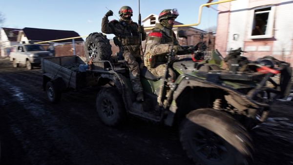 Russian soldiers ride a quad bike (ATV) in the village of Kazachya Loknya, which was previously held by Ukrainian troops and recently retaken by Russia's armed forces, in the Sudzha district of the Kursk region on March 18, 2025, amid the ongoing Russian-Ukrainian conflict. (Photo by TATYANA MAKEYEVA / AFP) Russia