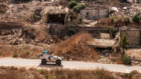 An armoured vehicle of the United Nations Interim Force in Lebanon (UNIFIL) moves past destroyed buildings along a road in the village of Kfar Kila in southern Lebanon near the border with northern Israel on August 27, 2025. AFP Lebanese army begins collecting weapons from Palestinian camps in Tyre