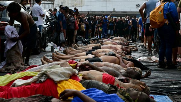 People line up bodies on Sao Lucas Square of the Vila Cruzeiro favela at the Penha complex in Rio de Janeiro, Brazil, on October 29, 2025, in the aftermath of Operacao Contencao (Operation Containment). AFP Death toll in Brazil’s Rio police raid rises to 132